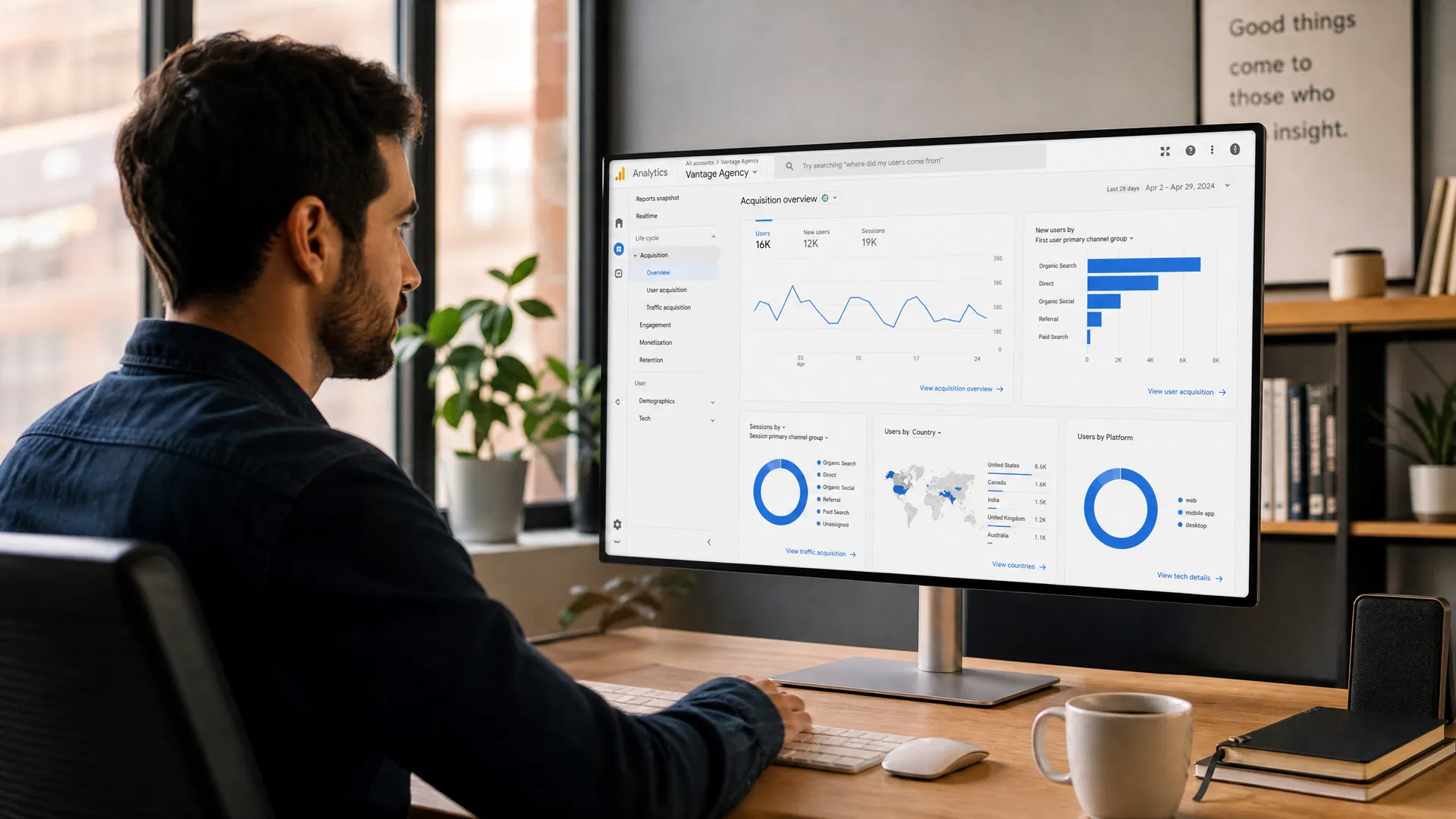 Marketing professional reviewing Google Analytics referral traffic dashboard on a large monitor in a modern office