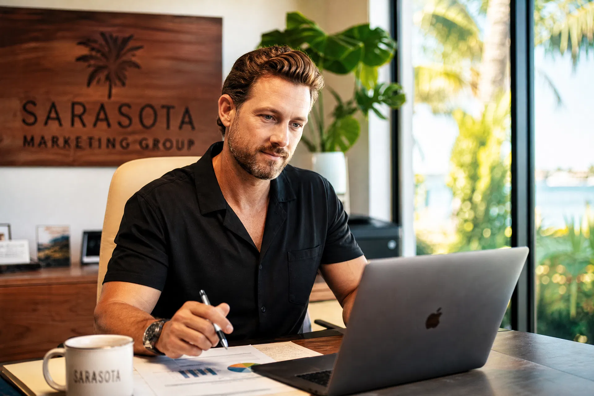 Sarasota business owner reviewing marketing budget and strategy at a bright modern workspace