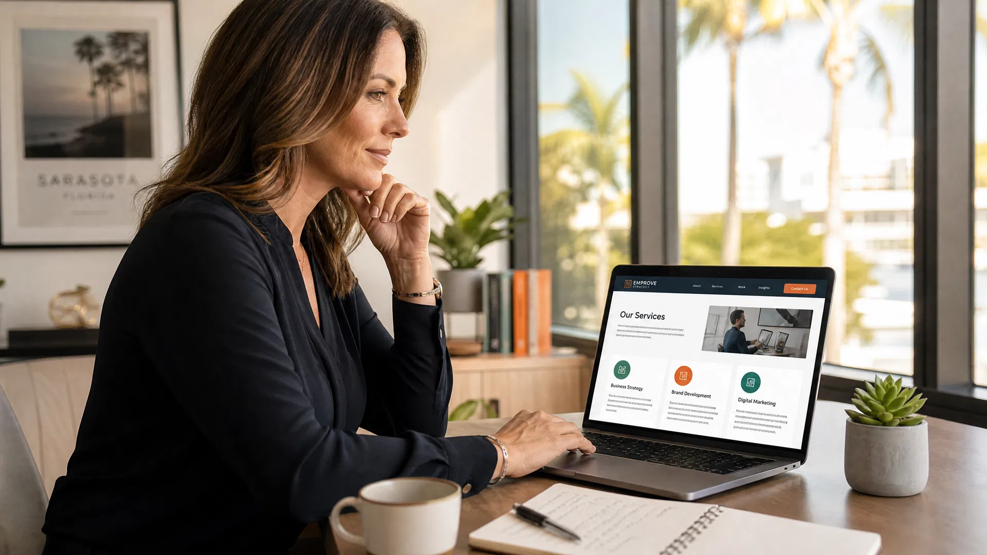Marketing professional reviewing service page structure on a laptop in a modern Sarasota office